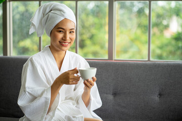 Asian young attractive woman wearing white bath robe sitting for Spa massage service. 