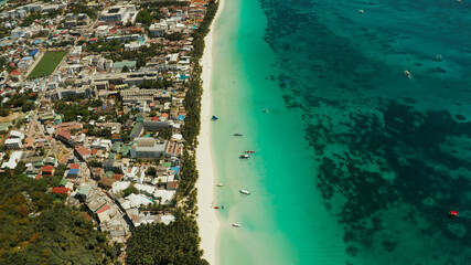 Tropical island Boracay with sandy beach and hotels view from the sea, aerial view. Summer and travel vacation concept. Philippines