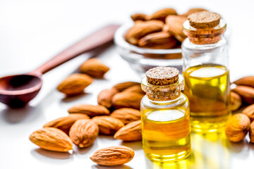 natural oil and almond in cosmetic set on table background