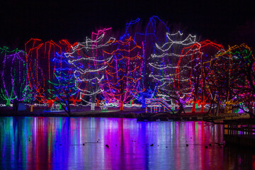 Colorful Christmas holiday lights reflecting across a frozen lake in Minnesota