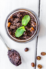 Organic spa with coffee scrub in cosmetic set on table top view