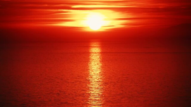 Seascape. Red sunset over sea water surface. View from cliffs of Maro Cerro Gordo Natural Park, Malaga province, Costa Del Sol, Andalusia, Spain.