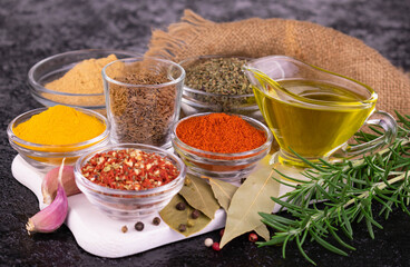 Many different spices and sauces on a black background.	