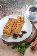 half-top view tasty cake slices with cup of tea on light background sweet biscuit cake pie