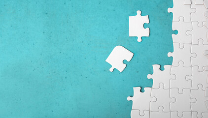 Many white piece of puzzle on blue background