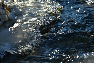 A river flowing between frozen banks