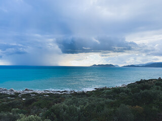 Stormy cloudy weather at the sea, azure water, seascape background