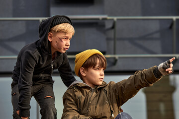 street boys looking at something, spending life outdoors, outcast boy pointing finger at side, show...