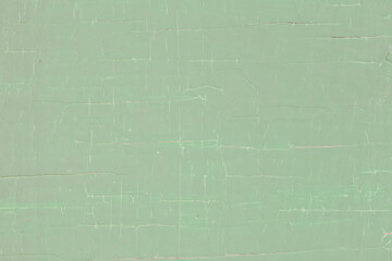 Green background from old peeling paint with cracks.