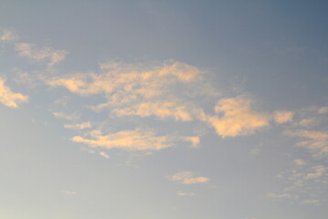 Pink clouds illuminated by the sun at dawn or sunset. Evening or morning dramatic sky