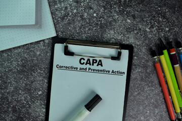 CAPA - Corrective and Preventive Action write on a paperwork on the table.