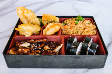 Chinese food box with fried rice tempura and sushi
