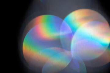 Lens flare, abstract bokeh lights. Reflection from glass or jewelry. Defocused shining colorful spots. Optical iridescent lens effect.
