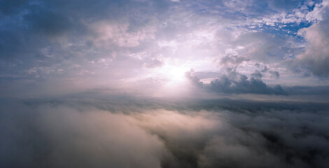 Obraz premium Dawn or sunset over the clouds, blue hour, aerial view.