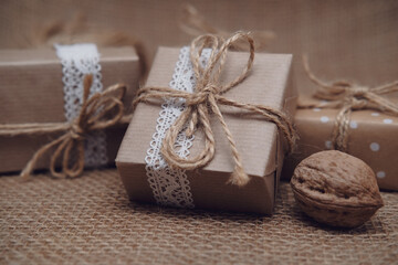 Brown craft paper gift boxes on jute background