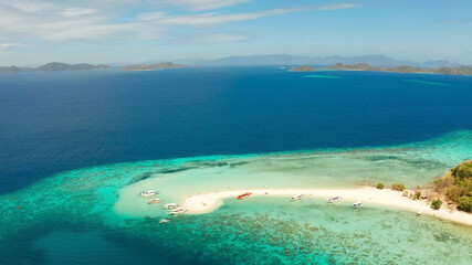 Aerial view tropical beach on island Ditaytayan. tropical island with white sand bar, palm trees and green hills. Travel tropical concept. Palawan, Philippines