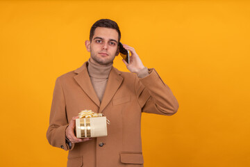 man with gift box and mobile phone isolated