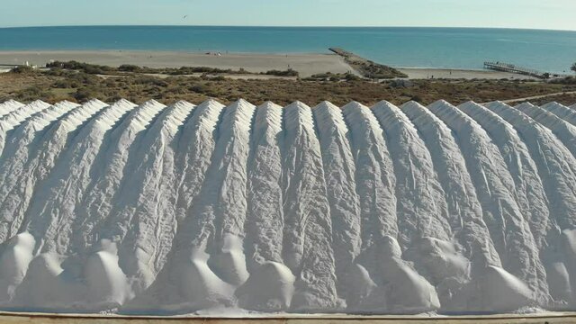 Aerial drone point of view white heaps of natural salt in Santa Pola. Province of Alicante. South of Spain, Europe. Production, industry concept
