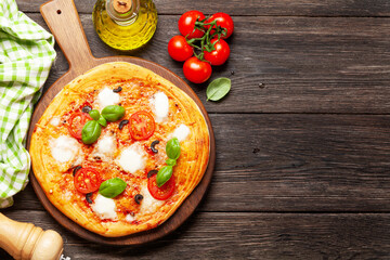 Tasty homemade pizza with tomatoes and basil