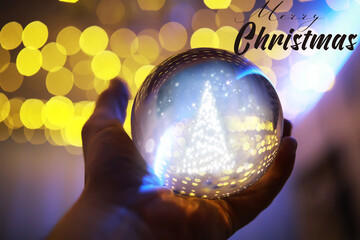 Crystal Ball on the floor with bokeh, lights behind. Glass ball with colorful bokeh light, new year celebration concept.