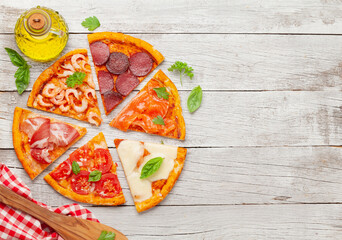 Tasty slices of different pizza