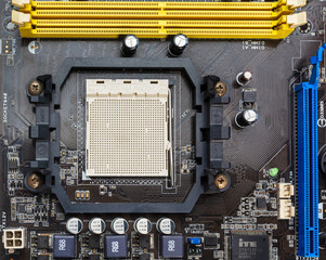 Fototapeta premium Close up view of chipset or am2 socket with ram and pci express slot on old computer motherboard.