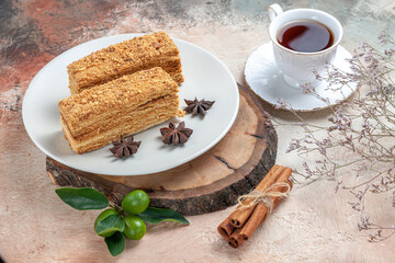 front view tasty cake slices with cup of tea on light background sweet biscuit cake pie