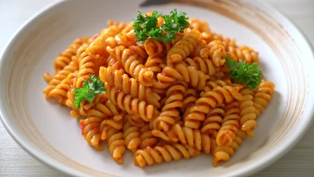 spiral or spirali pasta with tomato sauce and parsley - Italian food style
