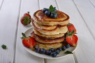 pancakes with fresh blueberry and honey on wooden rustic table