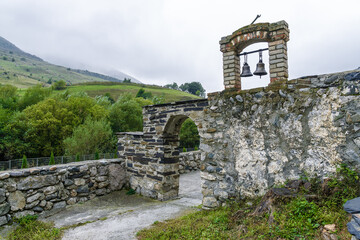 Cloudy view of the Church of Saint George of Dzivgis village in North Osetia Alania, North Caucasus, Russia