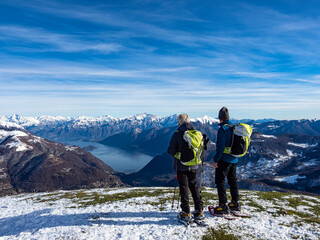 Snowshoeing scene in the italian alps