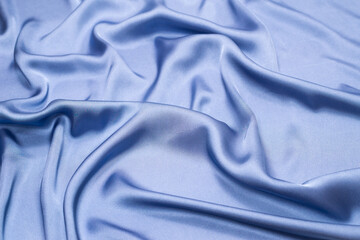 Obraz premium Blue silk or satin luxury fabric texture. Top view.
