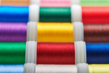 Background from spools with multicolored sewing threads