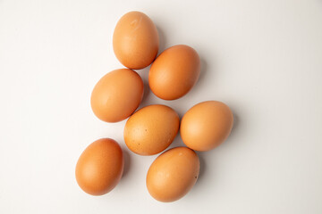 brown chicken eggs on color background