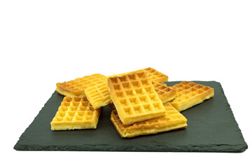 Delicious waffles on a stone board on a white background