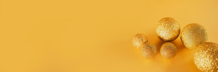 golden Christmas balls toys shiny for Christmas tree. yellow banner for the new year. copy space