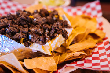 Close up mexican nachos topped with beef