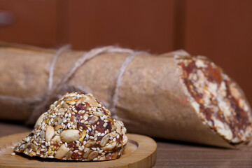 An energy bar made of dried fruits, nuts and seeds. Wrapped in edible paper. The wax seal is...