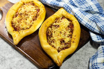 Traditional Turkish baked pide dish. Turkish pizza.  Pide of cheese and  meat