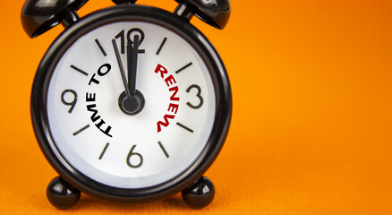 Time to renew symbol. Beautiful black alarm clock with words 'time to renew'. Beautiful orange...