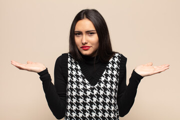 young hispanic woman looking puzzled, confused and stressed, wondering between different options,...