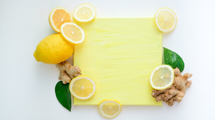 lemon slices leaves and ginger root on a yellow and pink background. foods that are good for health and immunity. the theme of protection from viruses . place and notepad for text and recipe. top view