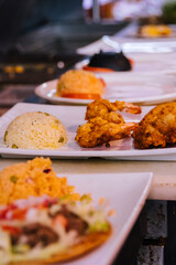 Food being set out in a Mexican restaurant kitchen