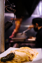 Plated food at a Mexican restaurant with chef in the background