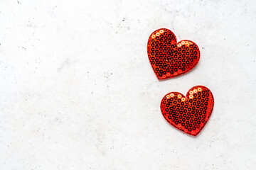 Valentine's day background - decorative hearts on white stone background. Flat lay, top view, copy space. Love concept.