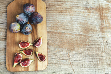 Figs cut on kitchen table. Copy space.