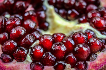 Close up of pomegranate seed. Open pomegranate fruit where ripe red pomegranate seeds are seen. Fruit pomegranate. Macro.