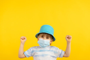Portrait of kid wearing protective mask against yellow background