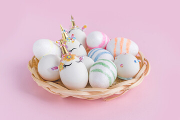 Unicorn eggs in the box isolated on pink background. Happy easter. Kids activity.
