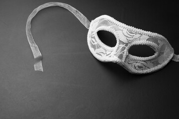 White festive carnival mask on a black background.Free space for text